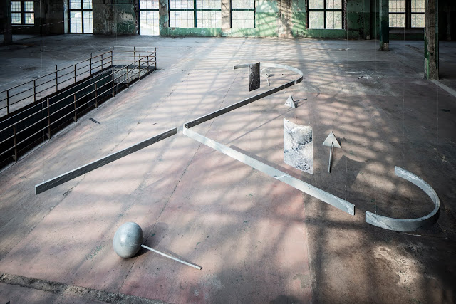 Ben Cain, Work in the Dark, installation view, Manifesta9. Hand painted (marble), plywood beams, machine, 4 sets of 3 objects-shapes, 1 set of 20 posters, 2012. (Ben Cain - Passive Imperative Participation Vibe 4)