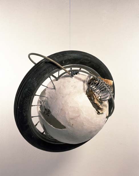 John Latham Cluster no. 2 from Cluster of Eleven, (1992)  Plaster, fragments of books, rubber, metal fittings, wire, wheel. 30 x 32 x 27 cm. Photo: Courtesy Lisson Gallery, London. (THE PRESENT MOMENT/THE WHOLE EVENT: PART ONE 2)