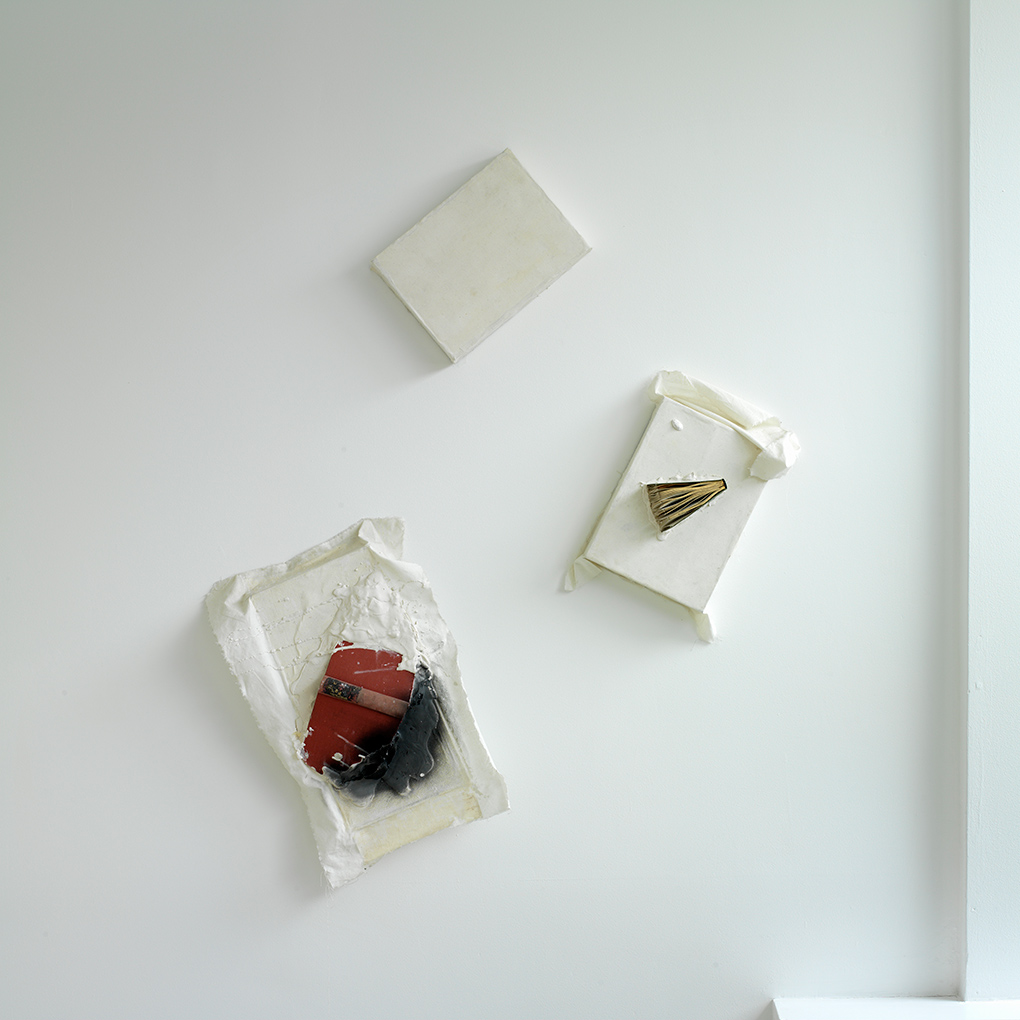 Book Relief Triad (2003/1959) Ink, plaster, books and white duck on wooden  boxes. Photo: Ken Adlard (FLAT TIME: 6)