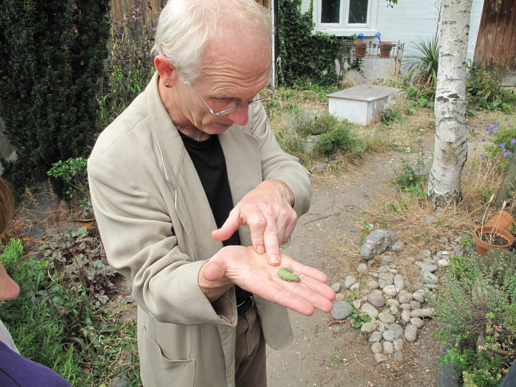 Patrick Wildgust, Curator of Shandy Hall, Laurence Sterne's home at the time he wrote Tristram Shandy, in the garden of Flat Time House with a large horned caterpillar. (AN OVERLOADED TRANSMISSION FROM A QUASI-PERSONAL STELLAR SOURCE 2)