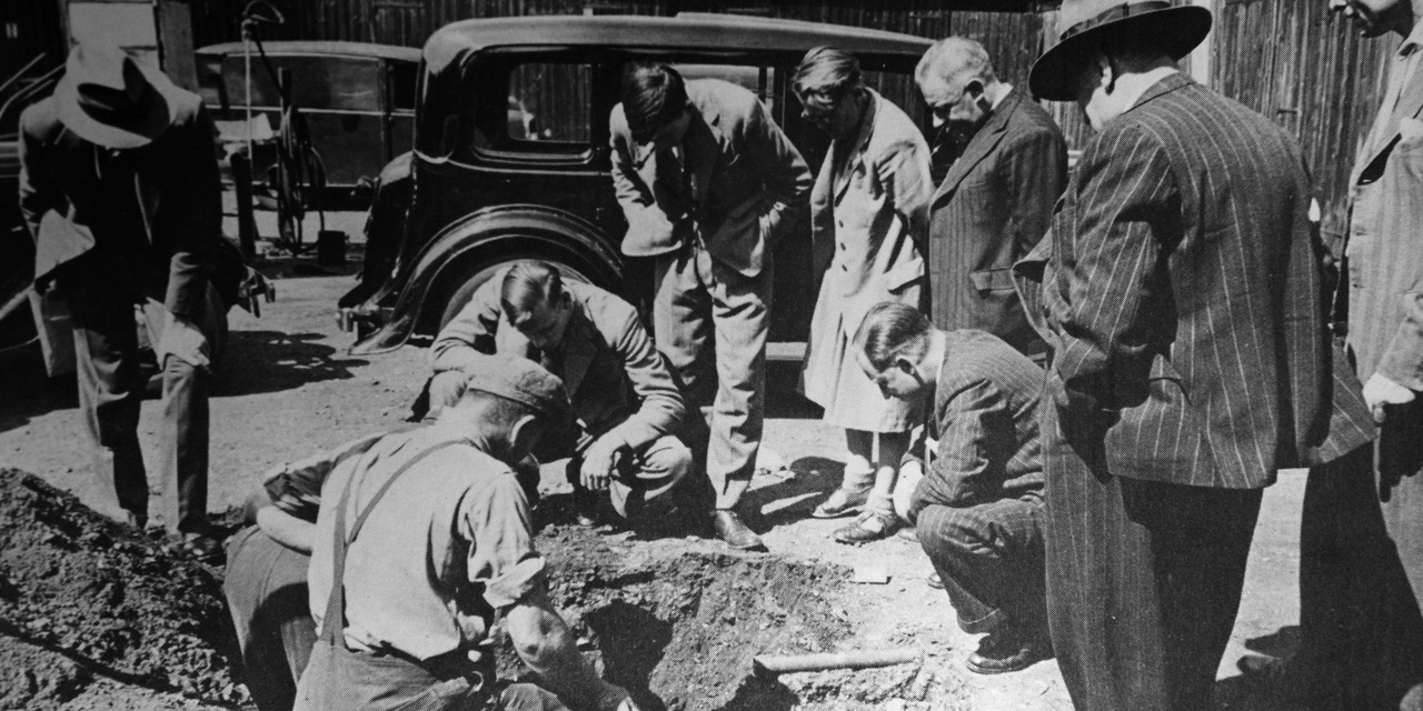 HMV executives and relatives of the artist Francis Barraud watch the exhumation of Nipper the dog, subject of his famous painting ‘His Masters Voice’ (1898), courtesy of EMI Archive Trust” (Phil Coy: Hydro Electric Domestic 3)